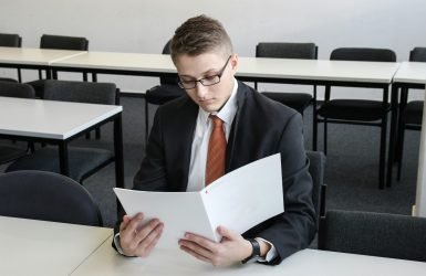 man holding folder in empty room