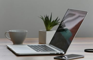 Silver Laptop and White Cup on Table